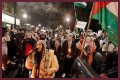 Four masked individuals remove Israeli flags at a Philadelphia cafe. - SarkariResult